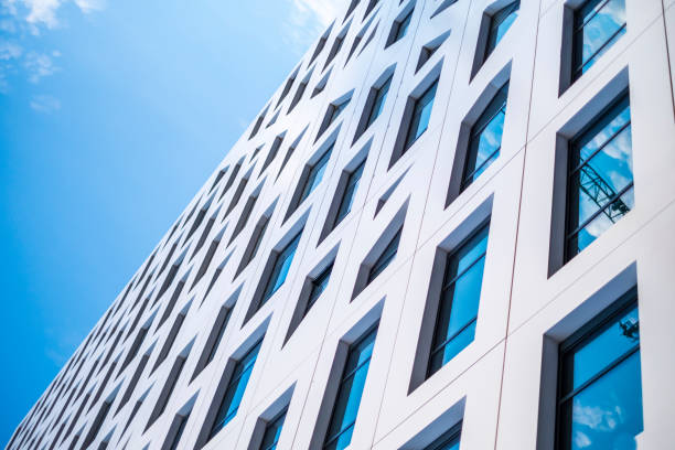 istock modern building with many glass windows in which the sky reflects 1027578074