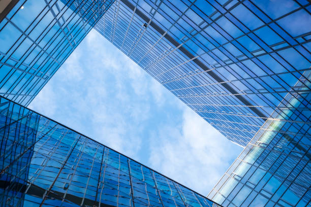 istock modern building with many glass windows in which the sky reflects 1027578084