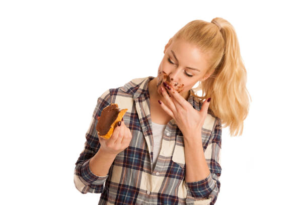 istock Young blond woman eating breakfast bread and nougat spread isolated over white background 1027578246