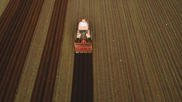 istock Tractor cultivates the land in the field 1027588974