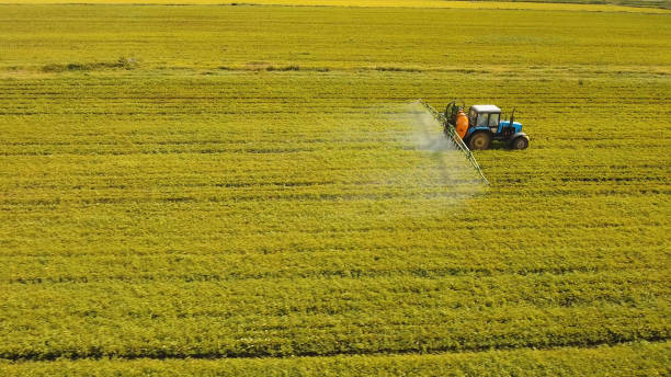istock Tractor is spraying fertilizers field 1027588996