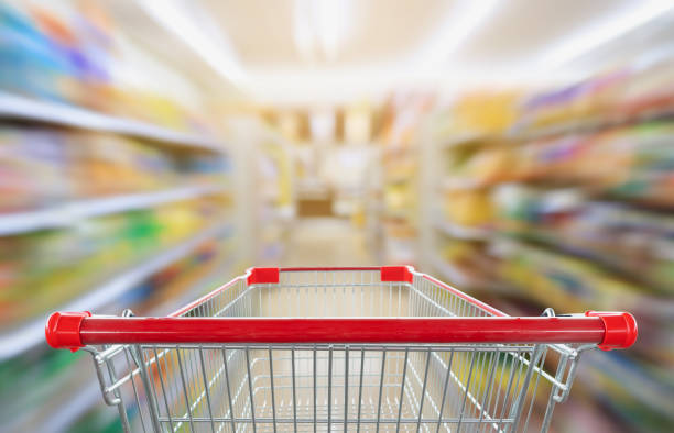 istock supermarket aisle blur abstract background with empty red shopping cart 1027589096