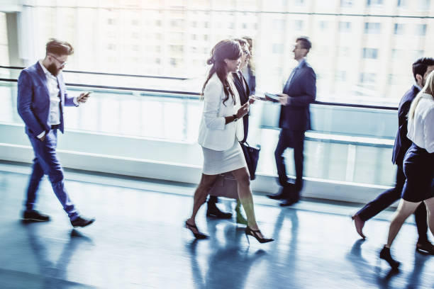 istock Business People Walking Down The Hallway 1027590454