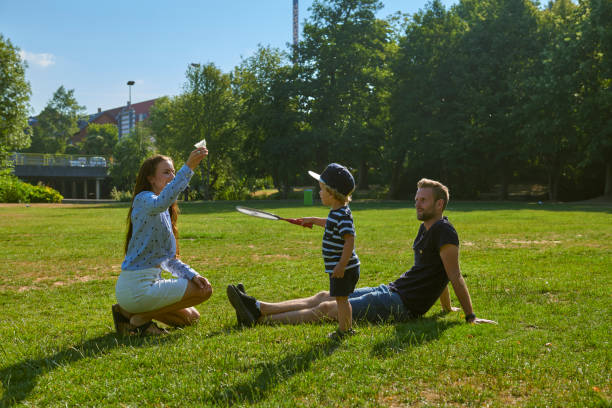 istock family having fun in the park 1027590628