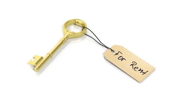 istock Tag with phrase For Rent on golden retro key , isolated on white background. 1027594036