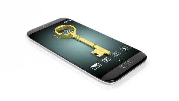 istock Golden retro key on smartphone screen, isolated on white 1027594120