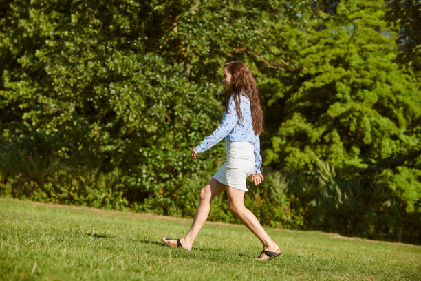 istock young woman in park running 1027604626