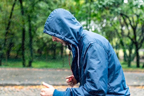 istock Man Jogging on a Rainy Day in the Park 1027614782