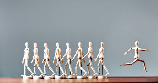 Rebel: single marionette breaks away from line of marchers