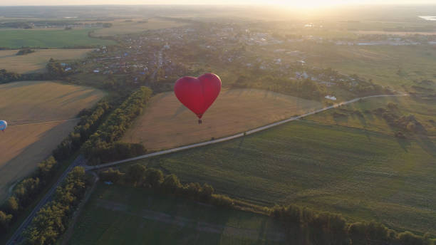 istock Hot air balloon shape heart in sky 1027618852