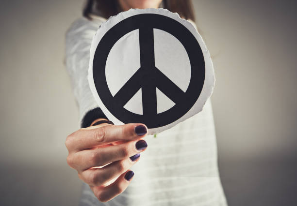 istock Female hand holds a Peace sign towards camera 1027619726