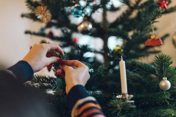 istock girl decorating christmas tree 1027623614