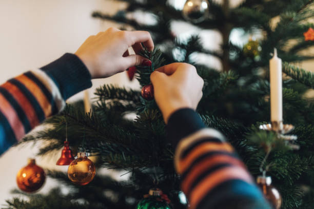 istock girl decorating christmas tree 1027623876
