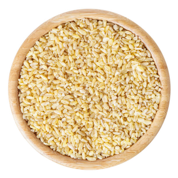 istock Uncooked bulgur in wooden bowl isolated on white background with clipping path 1027629946
