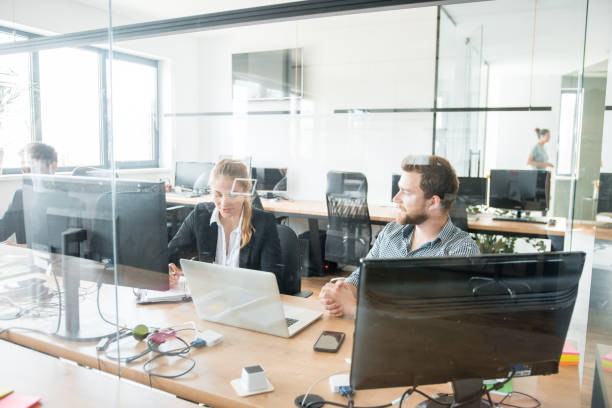 istock Two colleagues discussing new ideas at the office 1027634528