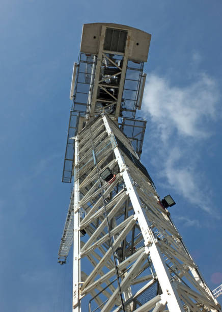 istock looking upwards view of a large white tower construction crane against a blue sky with clouds 1027634850