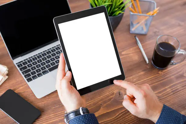 Unrecognizable business person working on tablet computer. Tablet vertical screen mockup.