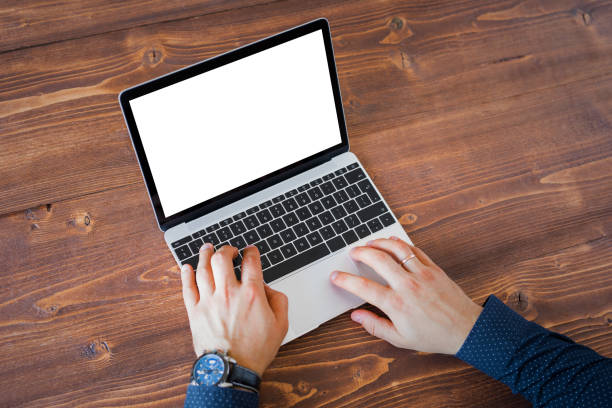 Unrecognizable person working on laptop computer. Laptop screen mockup.
