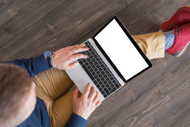 istock Man working on laptop computer. Laptop screen mockup. 1027637958