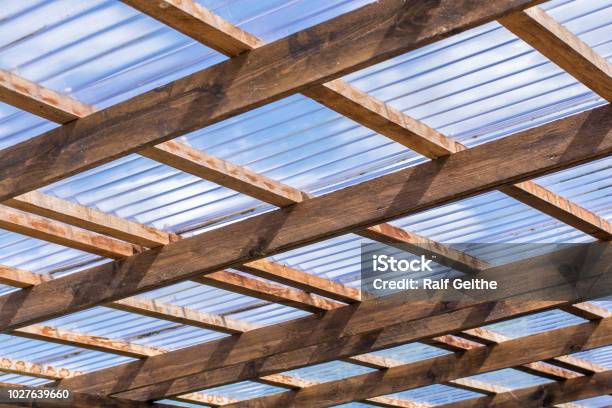 Roof Construction Of A Selfmade Carport Made Of Wooden Beams And Transparent Roof Panels Stock Photo - Download Image Now