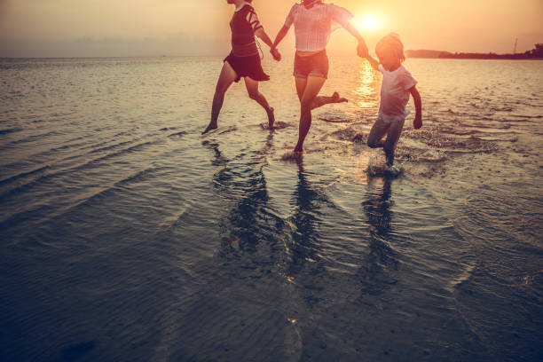 istock family is running on the beach 1027643102