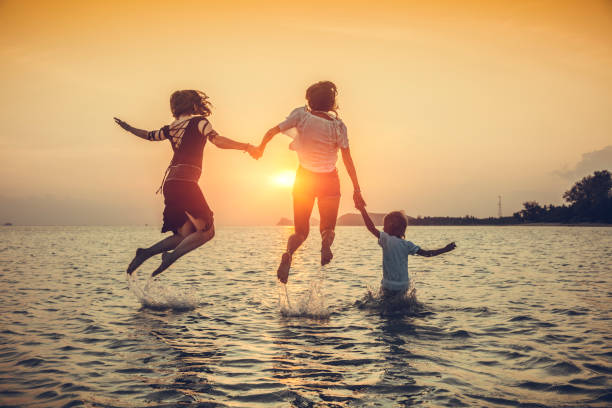 istock family is running on the beach 1027643112