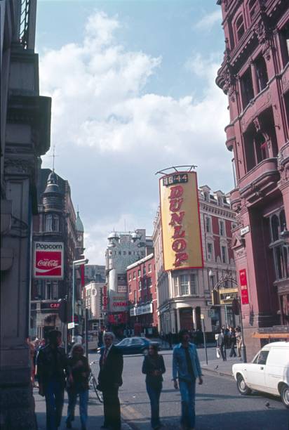 Street scene in London London, England, UK, 1973. Street scene with pedestrians, buildings, advertising, shops and street traffic in London. soho billboard stock pictures, royalty-free photos & images