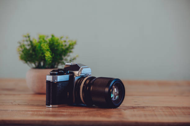 istock Old vintage camera on a wooden table. 1027649236