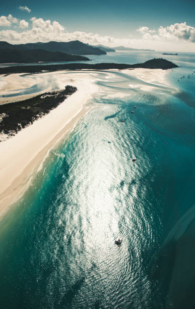 istock whitsunday beach with a boat 1027649462