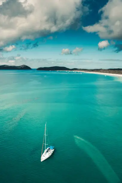 whitsunday beach with a boat