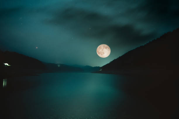 istock Full Moon over the mountain lake. Halloween concept 1027650212