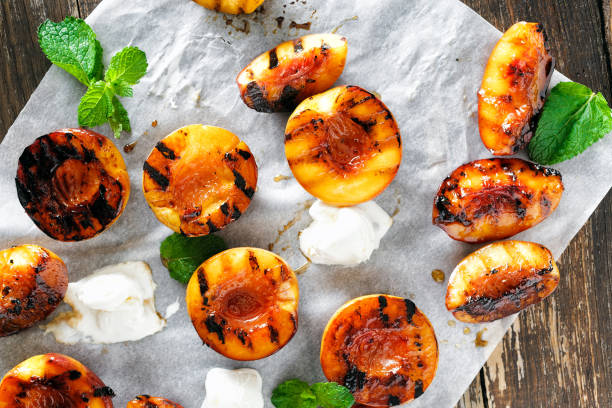istock Honey grilled peaches served with mint leaves and ice cream 1027652780