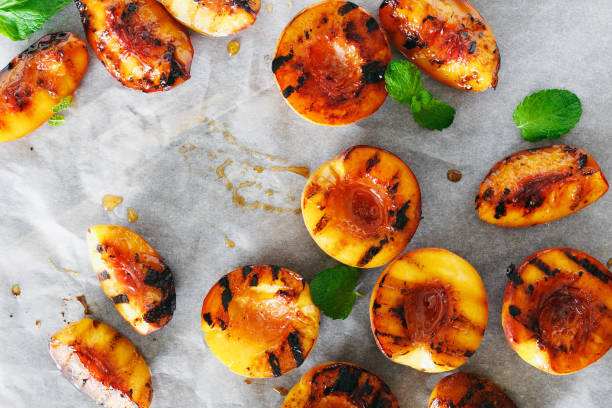 Top view grilled peaches served with mint leaves top view