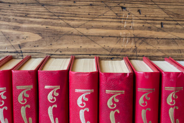 istock stack of hardcover books on a wooden table. Copy space for text 1027654290