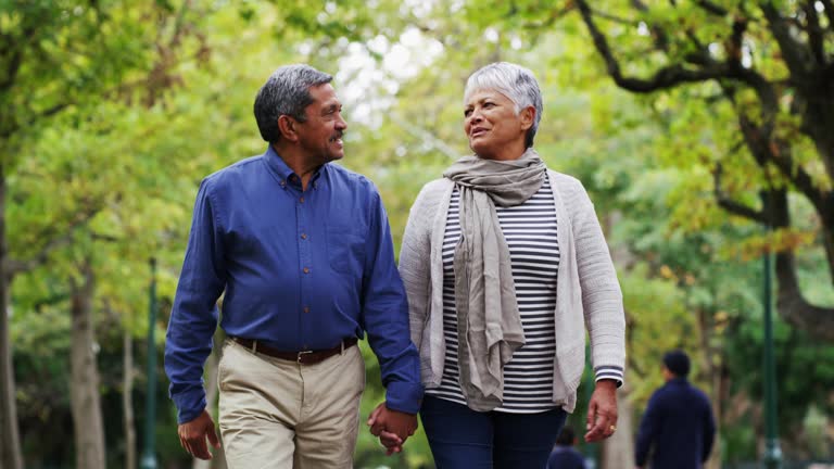 4k video footage of a mature couple out for a walk at the park