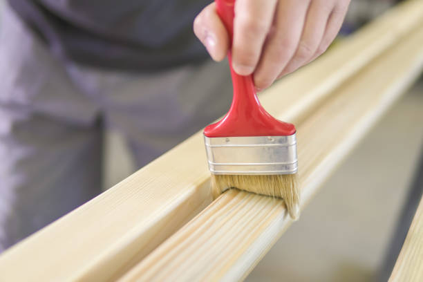 istock Young man painting an old wooden table 1027660282