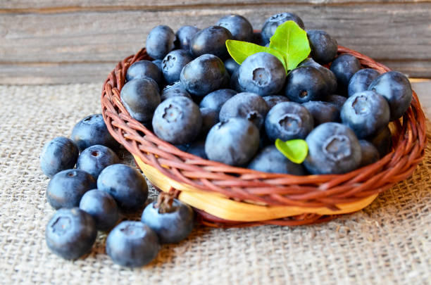 istock Freshly picked blueberries in a basket on a burlap cloth background.Fresh organic blueberry.Bilberries.Healthy eating,vegan diet or raw food concept. 1027676604