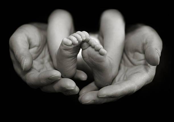 istock Baby Feet in Fathers Hands 102767703