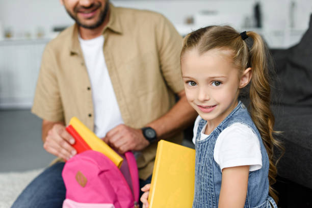 istock partial view of daughter and father packing backpack for first day at school, back to school concept 1027677566