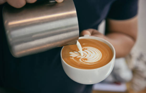 istock Barista making latte or Cappuccino with frothy foam, coffee cup in cafe. 1027683030