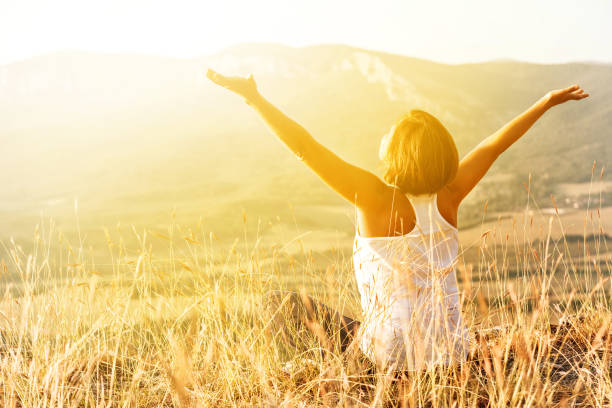 istock Happy woman meets sunrise in mountain 1027683304