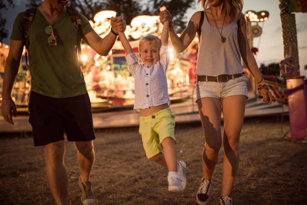 istock Young family with son on street fair. 1027686094