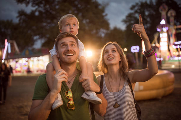 istock Young family with son on street fair. 1027686206