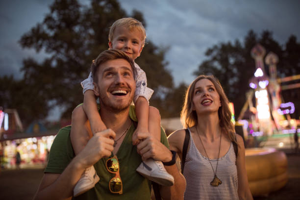 istock Young family with son on street fair. 1027686352