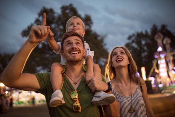 istock Young family with son on street fair. 1027686364