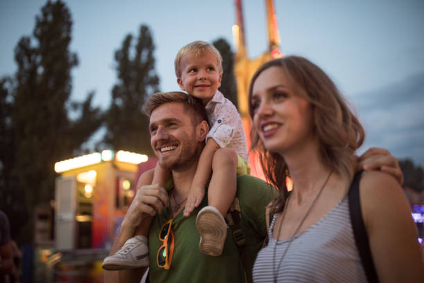 istock Young family with son on street fair. 1027686514