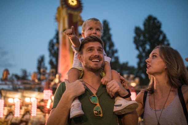 istock Young family with son on street fair. 1027686582