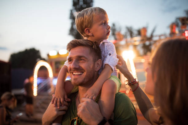 istock Young family with son on street fair. 1027686728