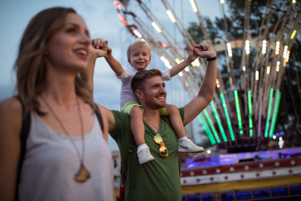 istock Young family with son on street fair. 1027686736