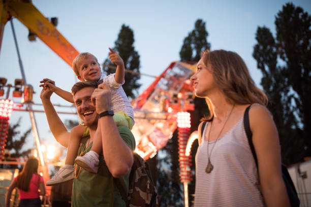 istock Young family with son on street fair. 1027686774